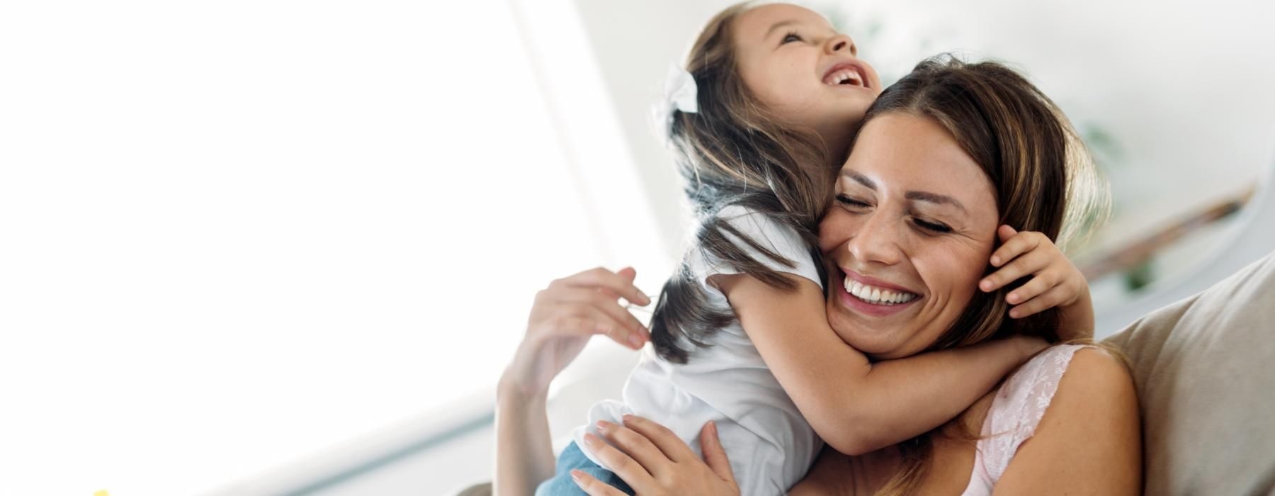 a woman holding a girl