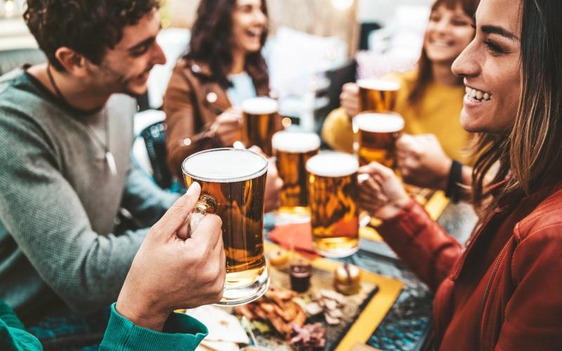 a group of people sitting at a table with beer glasses