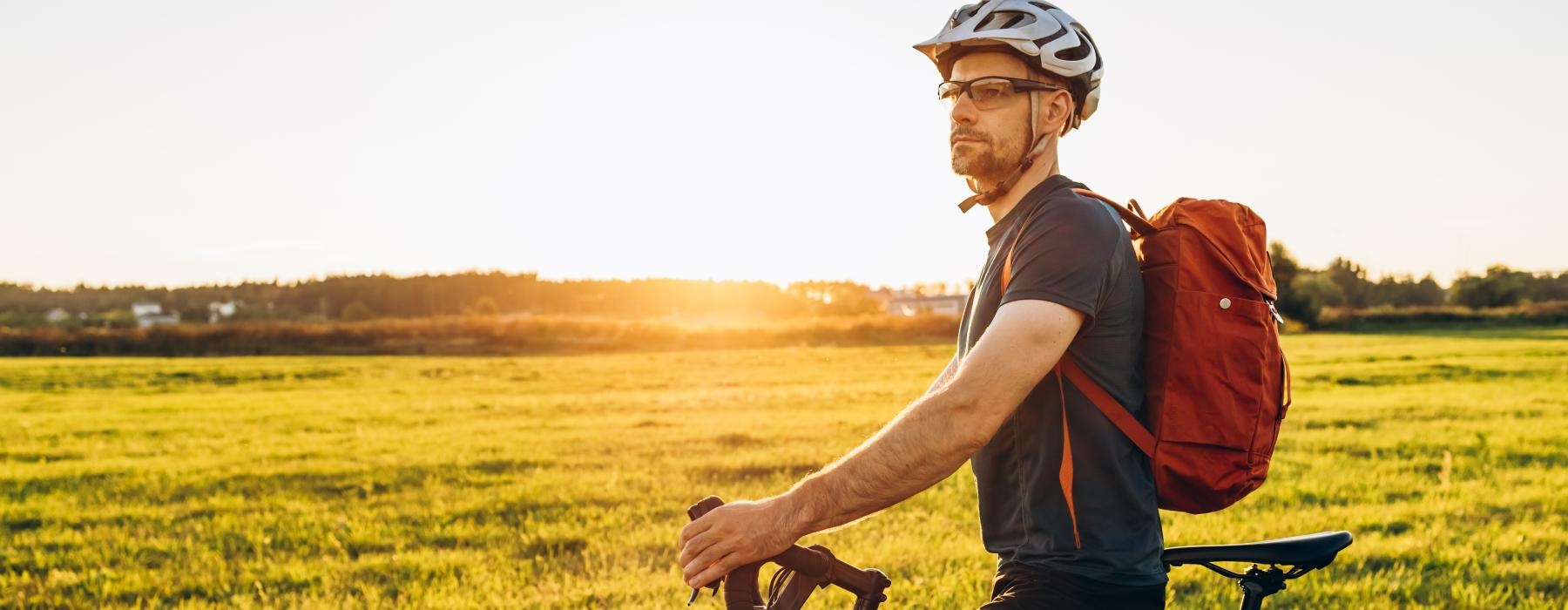 a man riding a bicycle in a field